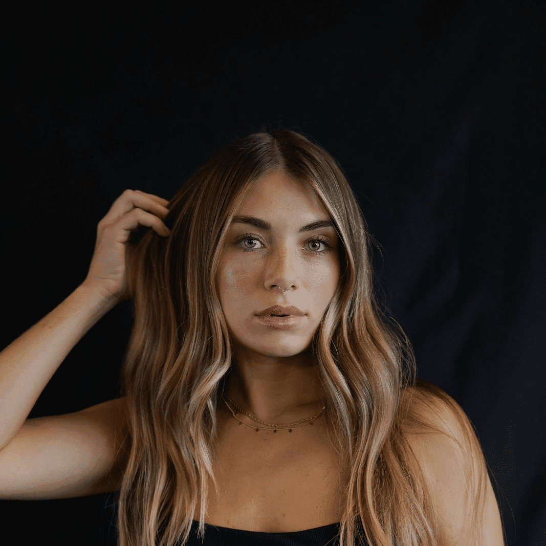 Portrait of Jessie, a professional stylist at MixxHouse Salon, showcasing their expertise and style.