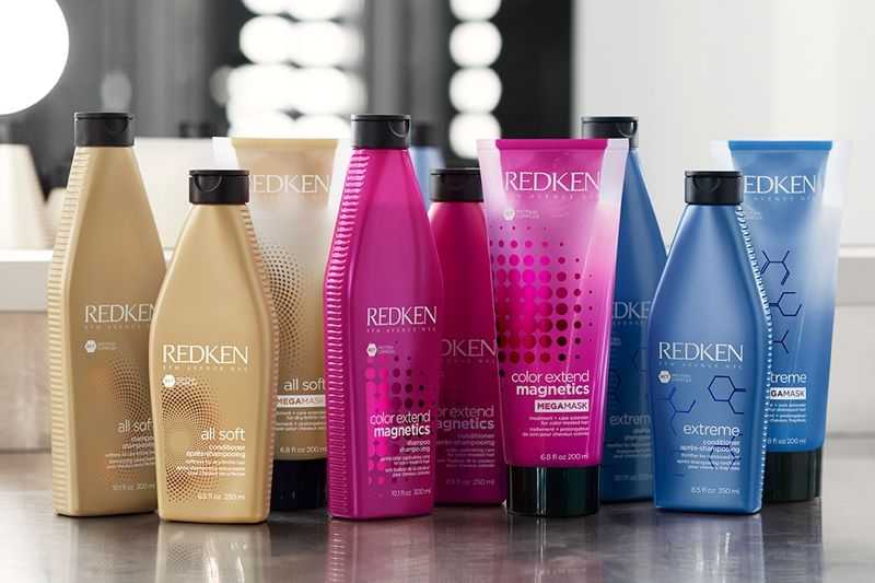 Assorted Redken hair care products displayed on a shelf.